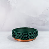 "Empty BLOSSOM bowl planter front view, showcasing copper base with intricate forest pattern."